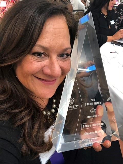 Renae Friedman smiles with her 2019 Summit Award